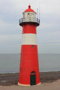 A red lighthouse with blue sky in the background Foto stock