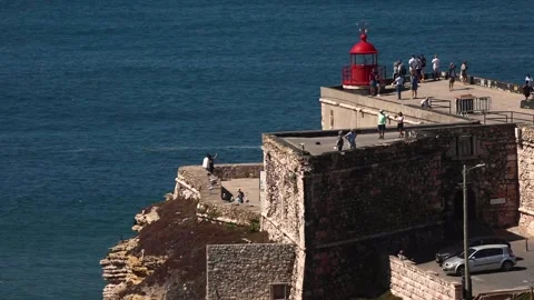 Red lighthouse on a cliff Stock Footage 250980529