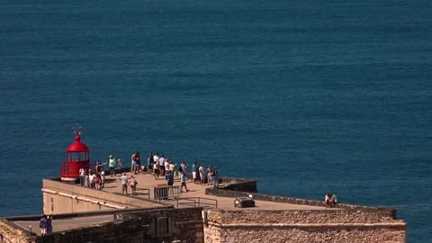 Red lighthouse on a cliff Stock Footage 250980620