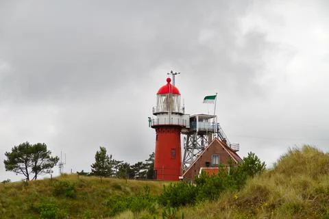 Red lighthouse on dune Stock Photos