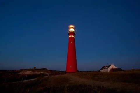 Red lighthouse in the night Stock Photos