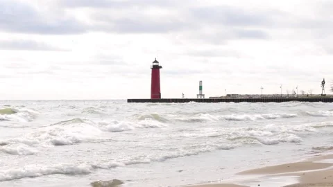 Red Lighthouse in the Ocean with waves crashing around it Video stock 242028649