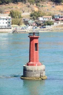 A red lighthouse on a rock Stock Photos