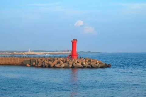 Red Lighthouse on the seawall Stock Photos