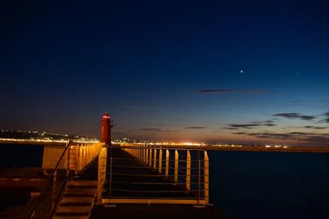 Red lighthouse at sunset Stockfoto's