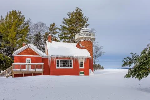 Red Lighthouse Under Deep Snow Stock Photos