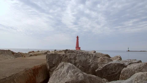 Red Lighthouse viewed from the rocks at Pere Marquette, Michigan. 4k60p Stock Footage 128857201