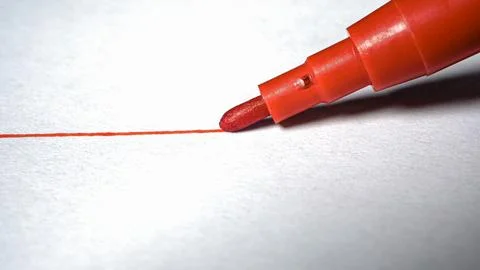 A red line with a felt-tip pen on white paper. Close up Stock Photos