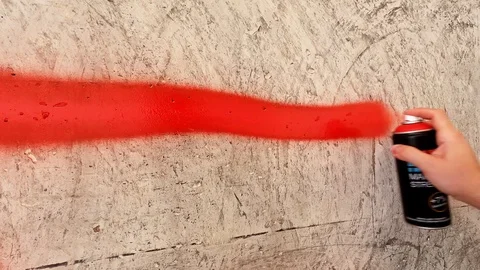 Red lines on the wall. A hand with a spray can draws lines. Stock Footage 126053509
