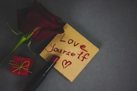 Red lipstick and a note with text 'Love yourself', a heart symbol I love me Stock Photos