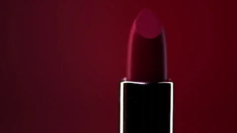 Red Lipstick. Matte dark red Lipstick over dark red background. Makeup Stock Footage 317008097