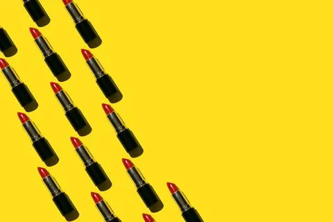Red lipstick pattern on the yellow background Stock Photos