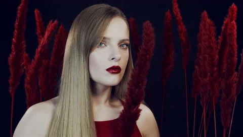 Red lipstick. Red fluffy feathers. Stock Footage 156644141