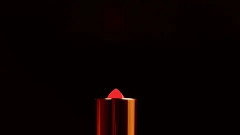 Red lipstick rotates on a black background. lipstick close up. Stock Footage 122199682