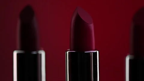 Red Lipstick set rotating. Matte red Colorful Lipsticks on red background Stock Footage 331052452