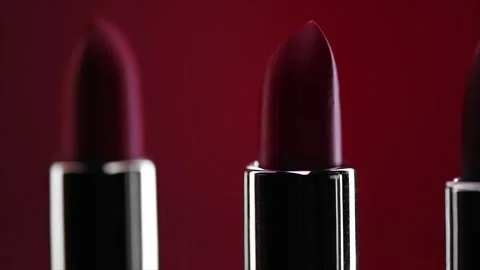 Red Lipstick set rotating. Matte red Colorful Lipsticks on red background Stock Footage 341983464