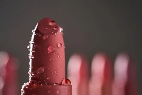 Red lipsticks with water drops on a dark background. Red lipsticks with wa... 写真素材