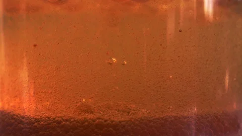 Red liquid with air bubbles Stock Footage 97890694