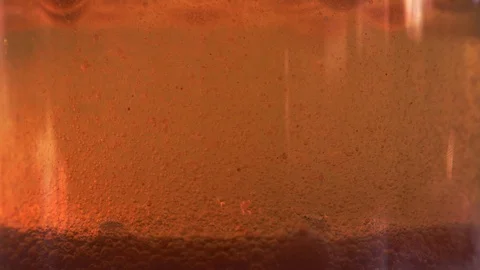 Red liquid with air bubbles Stock Footage 97939383