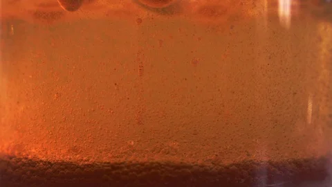 Red liquid with air bubbles Stock Footage 97939925