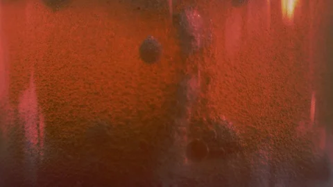 Red liquid with air bubbles Stock Footage 98064343