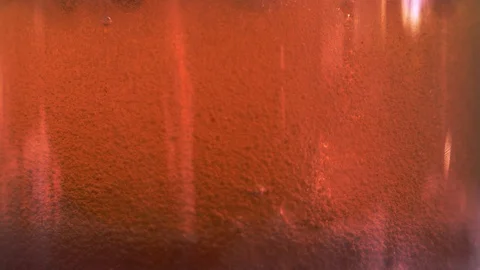 Red liquid with air bubbles Stock Footage 98065397