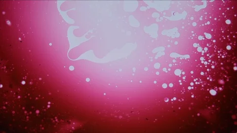 Red liquid art dye pattern with white spots Stock Footage 127723429