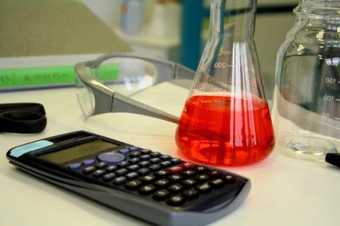 Red liquid in beaker on the table in the laboratory Stock Photos