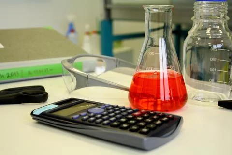 Red liquid in beaker on the table in laboratory Stock Photos