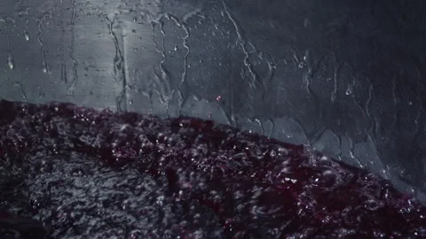Red liquid bubbles in a large container Stock Footage 263207788