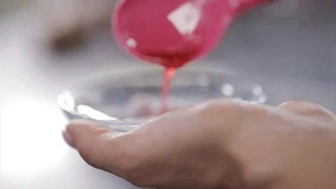 Red Liquid Jelly is Poured into a Small Glass Bowl Closeup Stock Footage 99162797