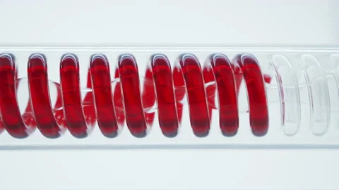  Red liquid or blood flows in a spiral into the flask.	 Stock Footage 144011683