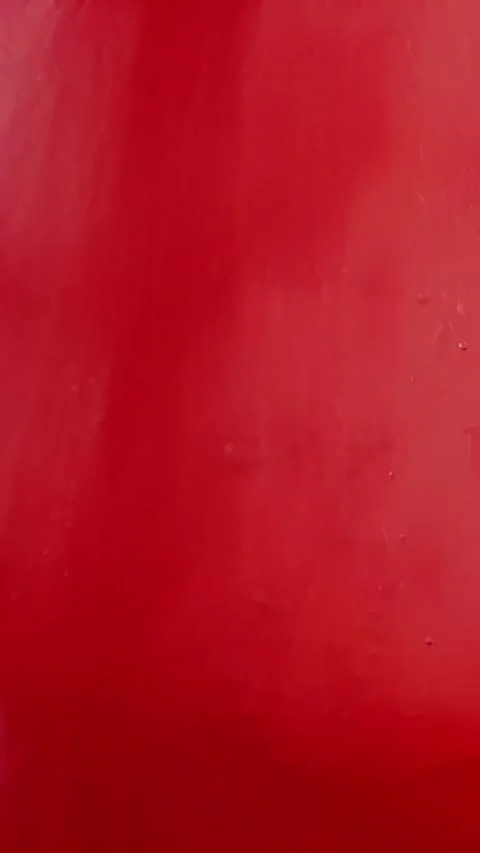 Red liquid paint transforming from light to intense crimson hues Stock Footage 309853780