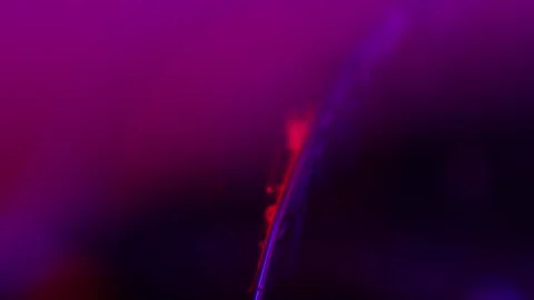 Red liquid particles on purple backgroun... | Stock Video | Pond5
