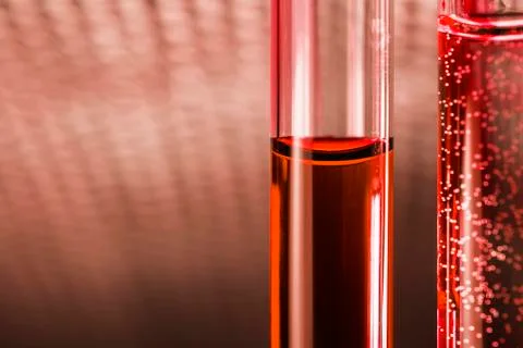 Red liquid posion in glass tube on abstract background Stock Photos