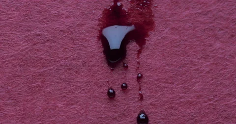 Red liquid spread and bloom down on pink background Stock Footage 147133245