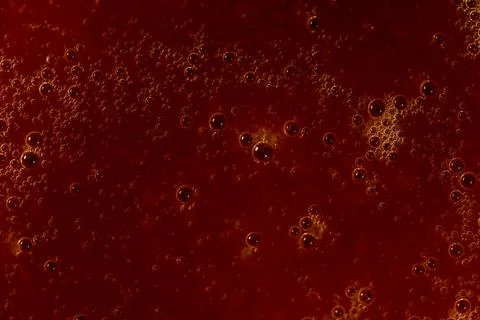 Red liquid texture with bubbles, abstract macro background Fotos de archivo