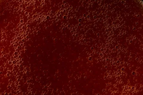 Red liquid texture with bubbles, abstract macro background 写真素材