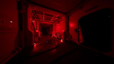 Red lit interior of a space station corridor during nighttime operations Stock Footage 312383346
