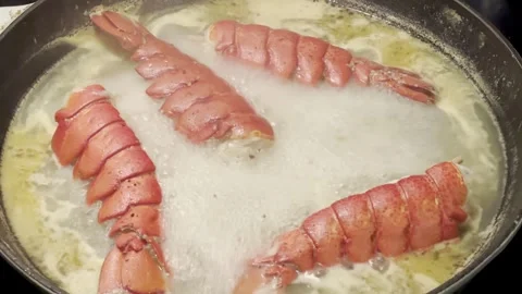 Red lobster tail being prepared in pan Stock Footage 273260646
