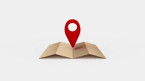 Red location marker in the center of a folded paper map. Video stock 249286402