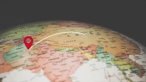 Red location pin drops on spinning vintage world globe map Stock Footage 342952886