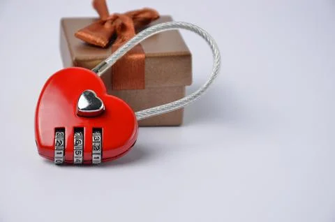 Red lock, gift box close-up on a blue background. Valentine's Day. Stock Photos