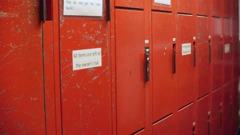 Red lockers in a locker room at a high school with vending machine in Stock Footage 163269743
