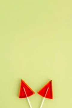 Red Lollipops in the shape of a triangle on a yellow background Stock Photos