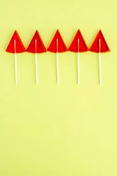 Red Lollipops in the shape of a triangle on a yellow background Stock Photos