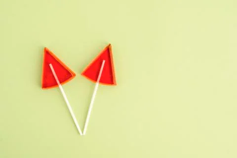 Red Lollipops in the shape of a triangle on a yellow background Stock Photos