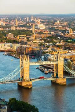 Red London bus crossing Tower Bridge, from above, London, England, United Stock Photos