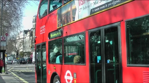 Red London bus leaving stop commuters sightseeing Stock Footage 48473760