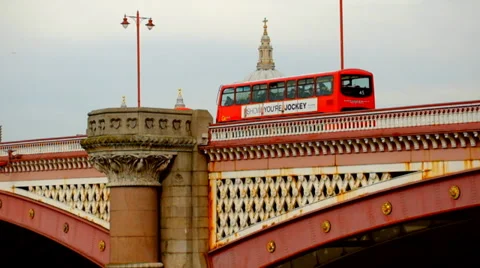 Red London bus passes over bridge Stock Footage 36610022